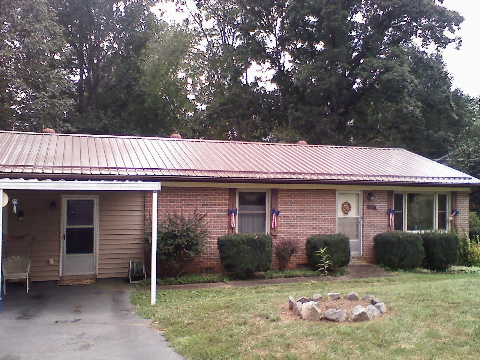 Bronze metal roof and carport on a brick ranch home — Roof Repair work by our crew in Seaford
