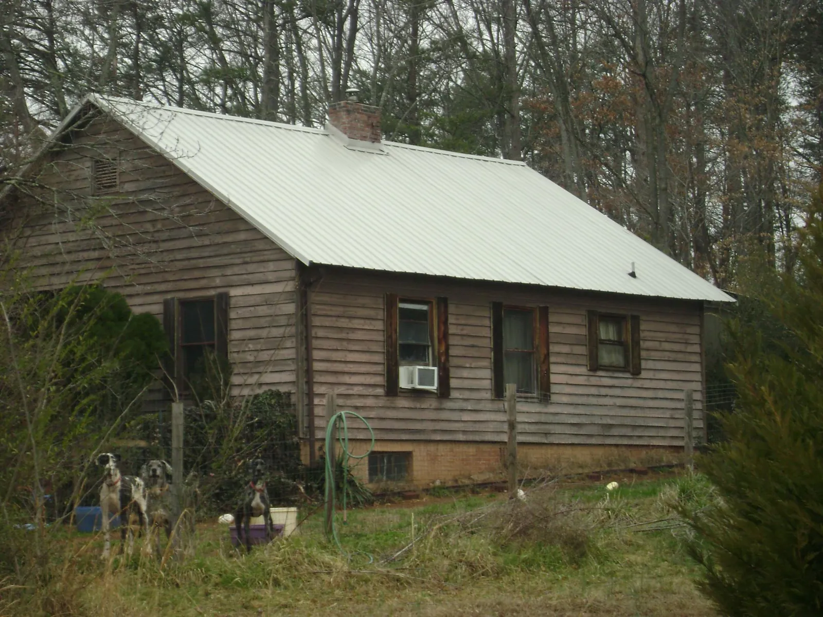 White metal roof on an old wood sided farmhouse, from a Metal Roof Installation job in Seaford